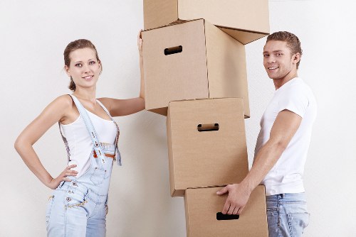 Staff using protective equipment while moving heavy items